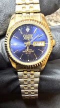 SWANK FM295 Mens Watch Gold Tone Blue Dial Day Date Two-Tone Diamond Accent